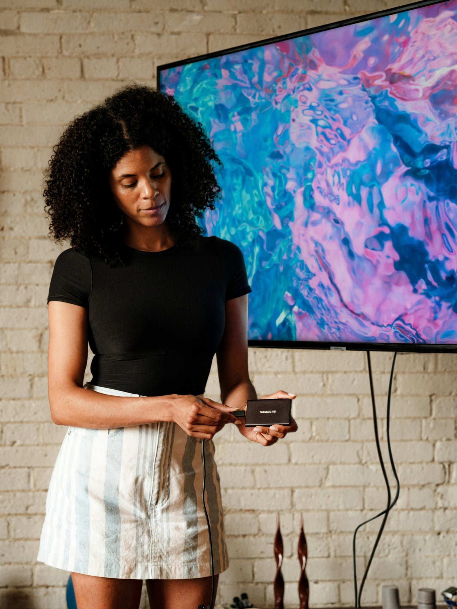 A woman standing in front of a flat screen TV